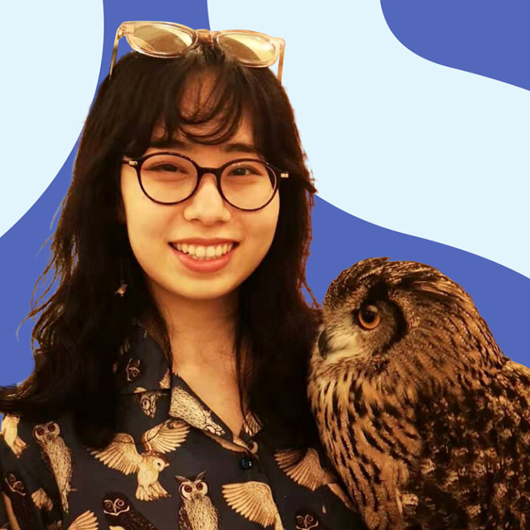 A young woman with glasses smiling next to a large owl, both set against a blue background with abstract shapes. the woman wears a bird-patterned shirt and sunglasses on her head.