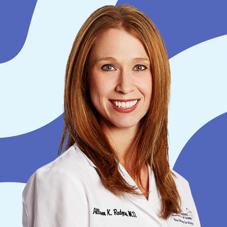 A professional portrait of a woman with long, straight reddish-blonde hair, wearing a white lab coat with a name tag. she smiles warmly against a blue and white abstract background.