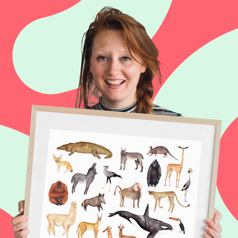 A woman with tousled hair smiles while holding a framed illustration of various animals against a playful pink and teal swirled background.