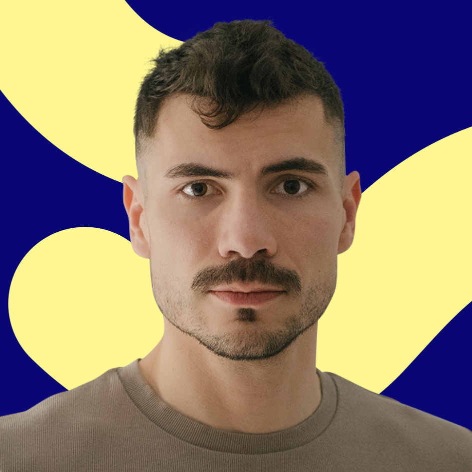 Man with short hair and a mustache, wearing a beige shirt, against a blue background with yellow shapes.