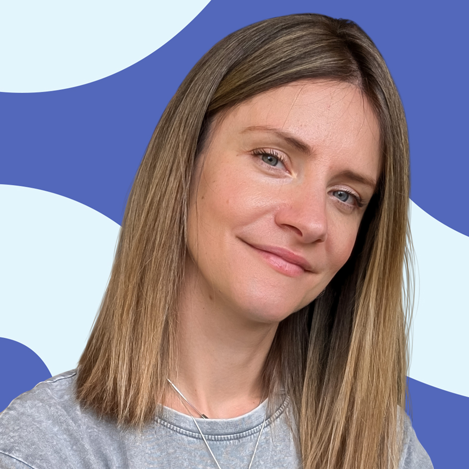 Woman with straight blonde hair smiling slightly, in front of a blue and white abstract background.